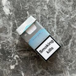Cigarette cases UK shown beside a lighter and premium Marlboro pack