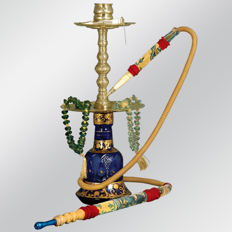 A traditional Turkish hookah with a bowl of flavored tobacco beside it